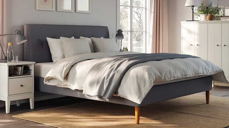 IDANÄS Upholstered bed with mattress in an airy bedroom