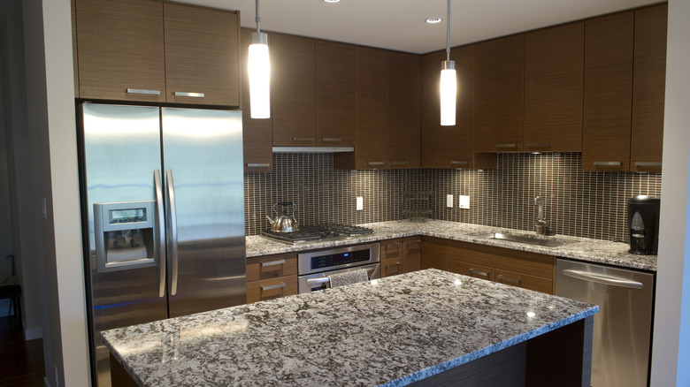 Dark kitchen with grey and black granite countertops