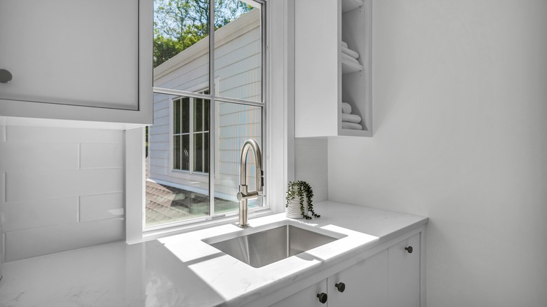 Small kitchen sink with white quartz countertops