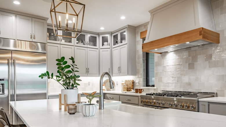 Large kitchen with white countertops and white cabinets