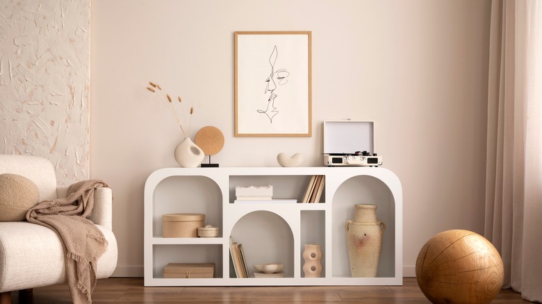 neutral decorations on white shelves