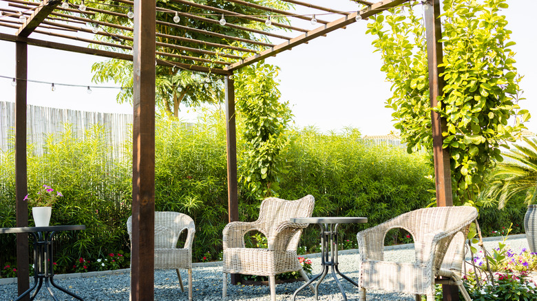 Wooden pergola over gravel patio