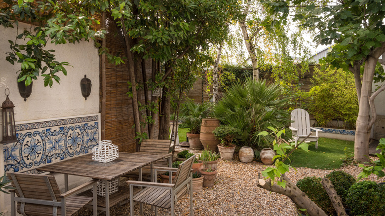 Outdoor dining table and chairs on gravel patio