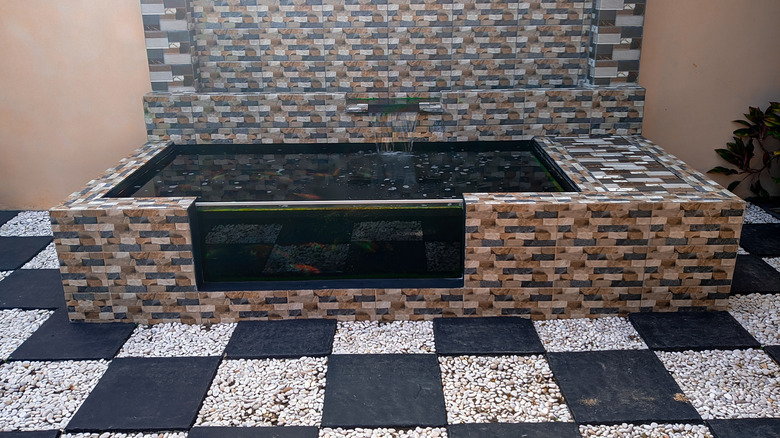 Fountain on chckerboard gravel patio