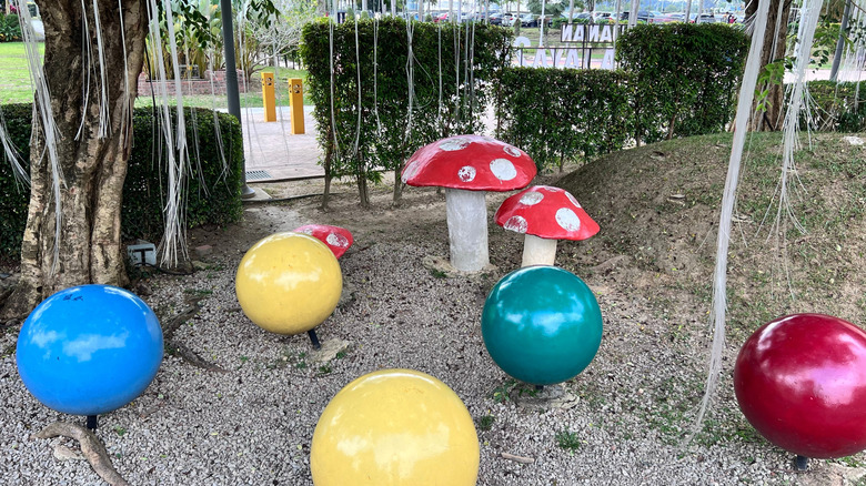 Gravel patio with colorful sculptures