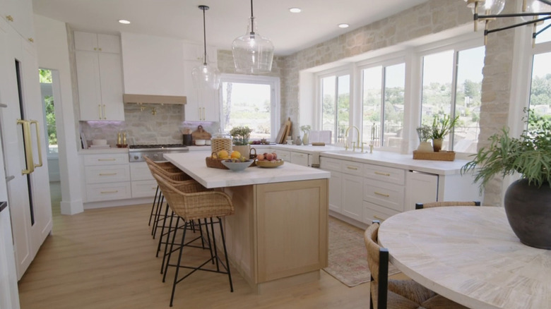A kitchen with a natural stone backsplash