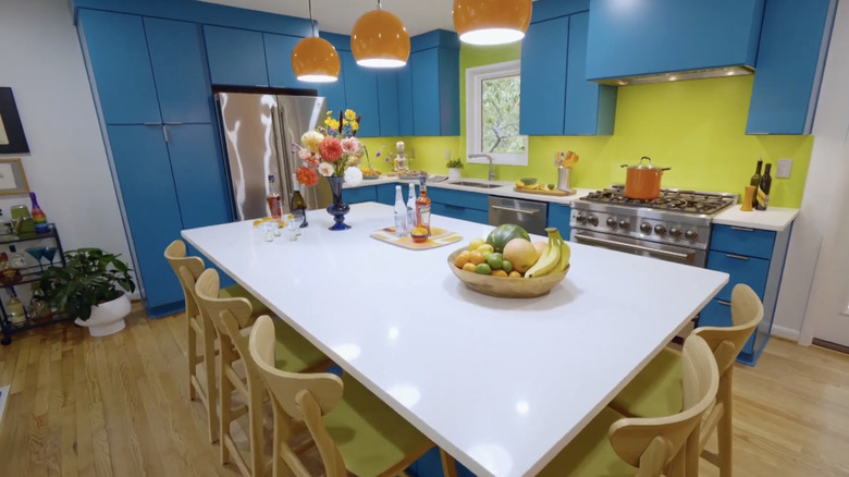 A bright retro kitchen with a lime green backsplash.