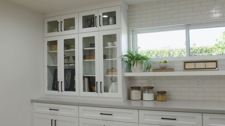 A kitchen with counter to ceiling cabinets