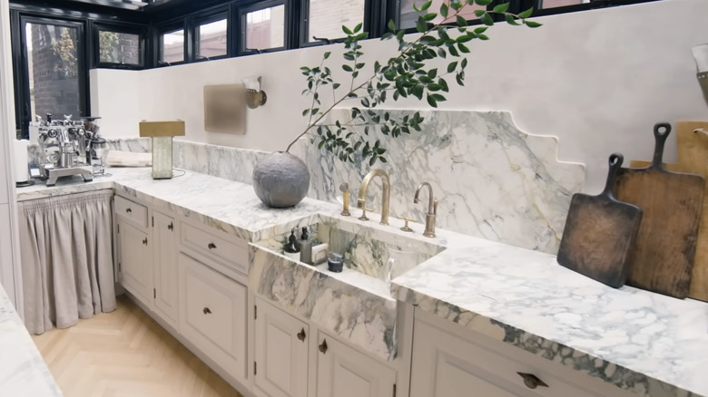A designer kitchen with modern marble countertops.