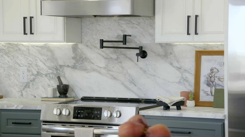 A marble countertop and backsplash in a modern kitchen.