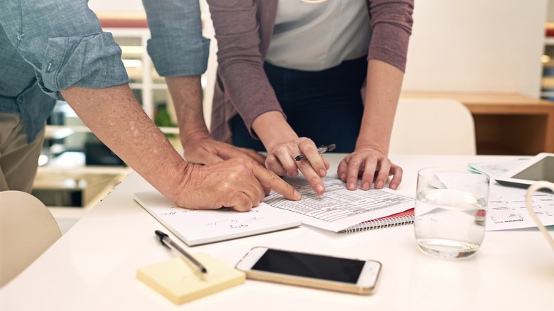 Two people reviewing budgets