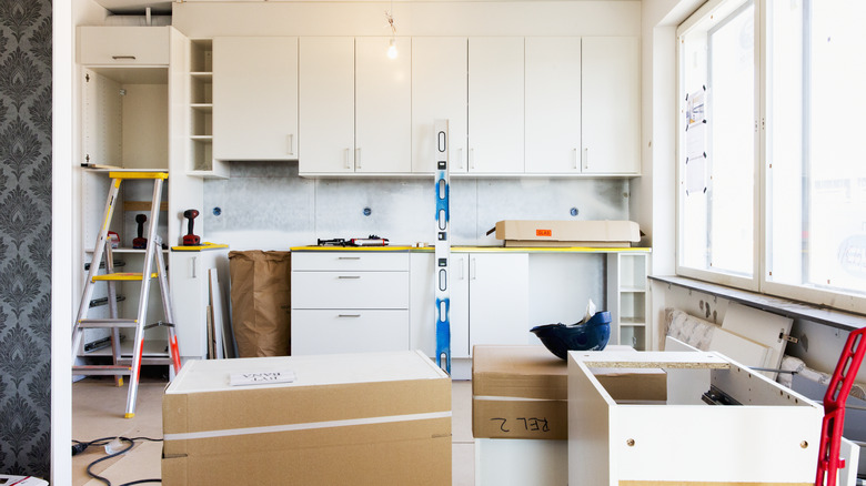 Kitchen with white cabinets in the middle of a remodel