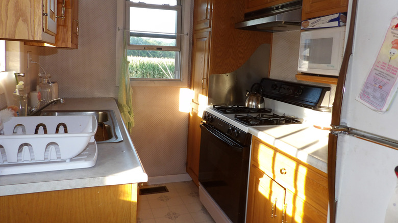 A small, cramped kitchen without much natural light