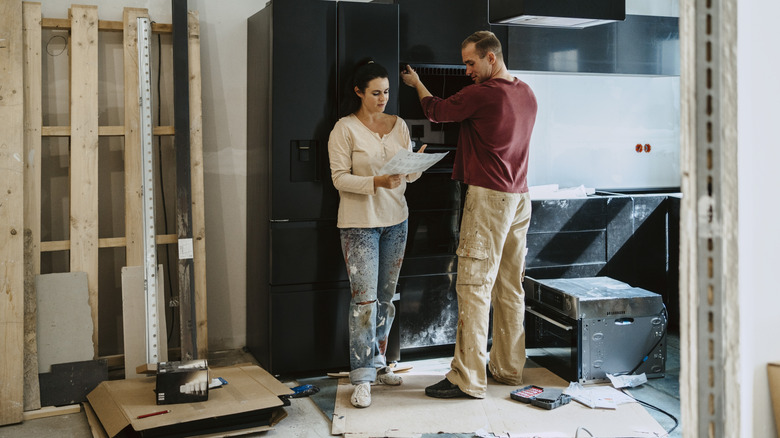 Couple in the middle of a renovation discussing the plans