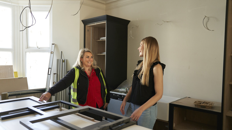 General contractor talking to the homeowner in a partially remodeled kitchen
