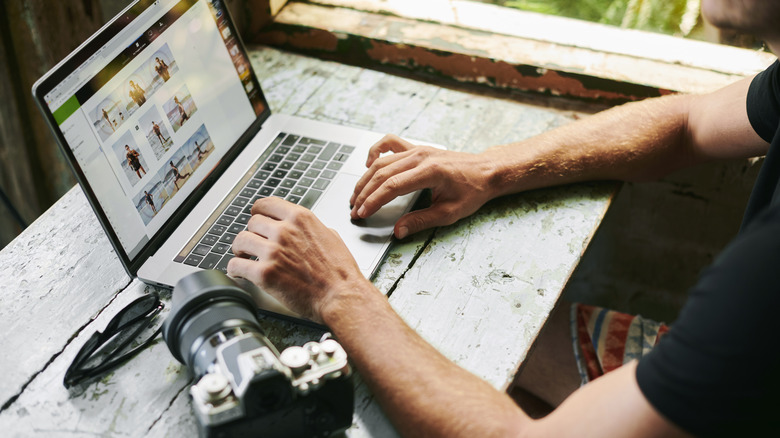 Person reviewing photos on a laptop