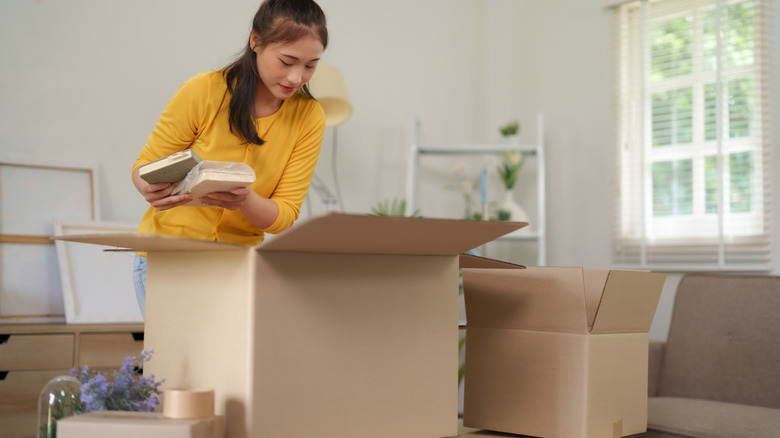 Woman packing books in a cardboard box
