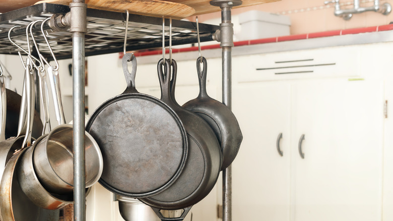 Pots and pans hanging beneath a kitchen island