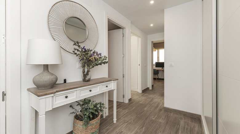 A tidy front entryway with a table and mirror