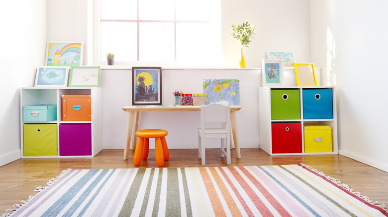 An organized toy room with storage shelves and a kid-sized table