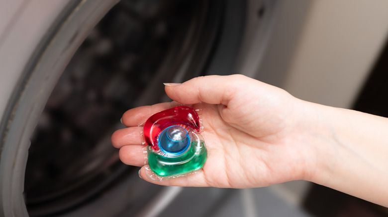 A detergent pod in a person's hand