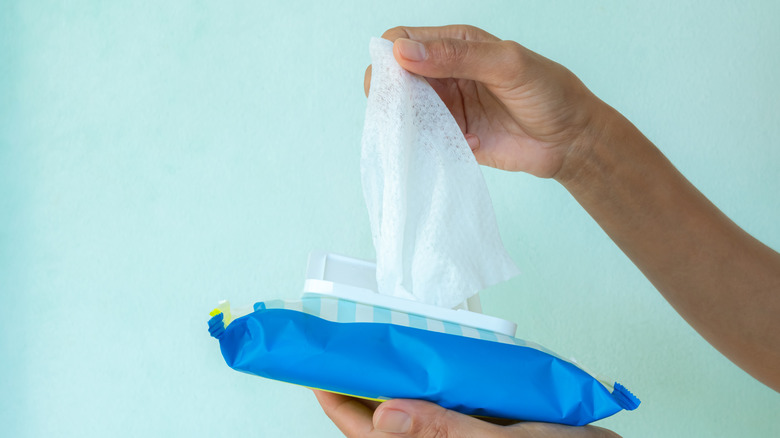 Polyester cleaning wipe being pulled out of packet