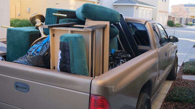 A pickup truck with furniture in the back