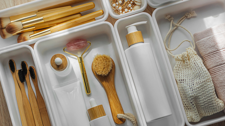Organized bathroom drawer with containers and separate items