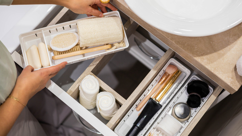 bathroom drawer with a variety of containers and items