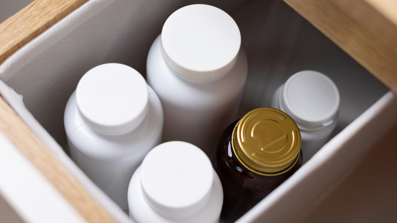 Bathroom drawer with products and bottles standing up