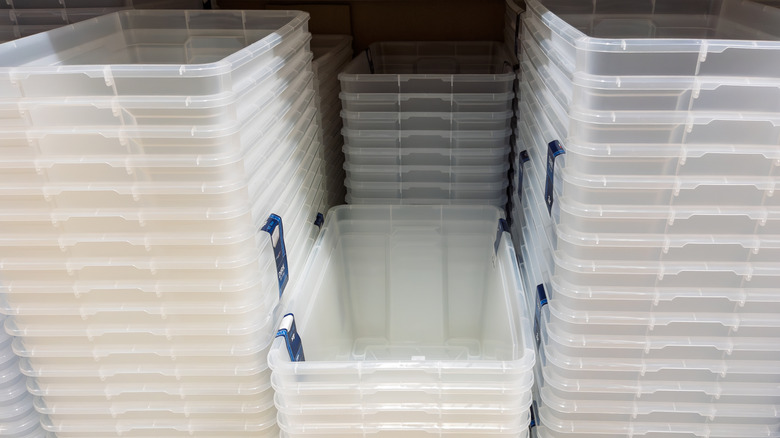 Stacks of clear plastic storage boxes on the shelf at the store