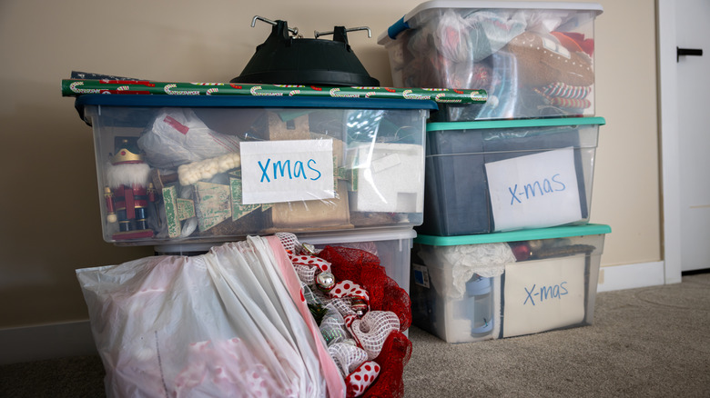Holiday decor in plastic bins stacked on top of each other