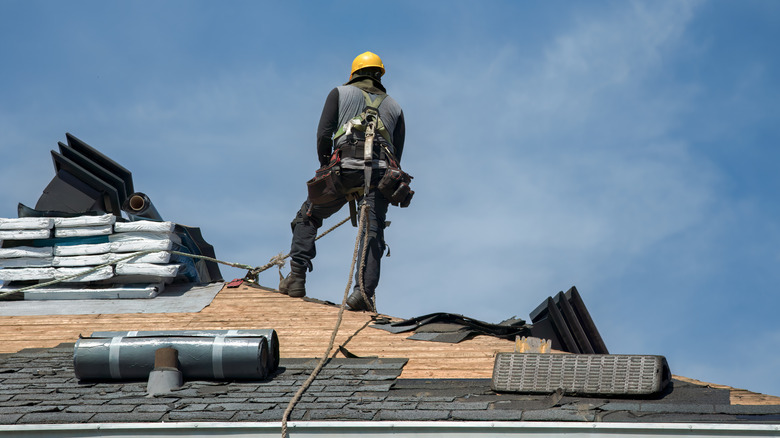 A construction expert works to install a new roof