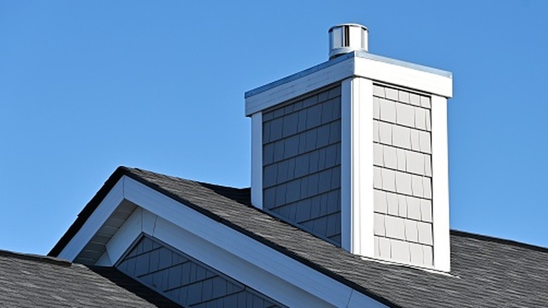 Chimney on a gray roof of a home