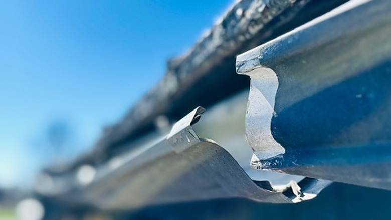Broken gutter on the side of a house