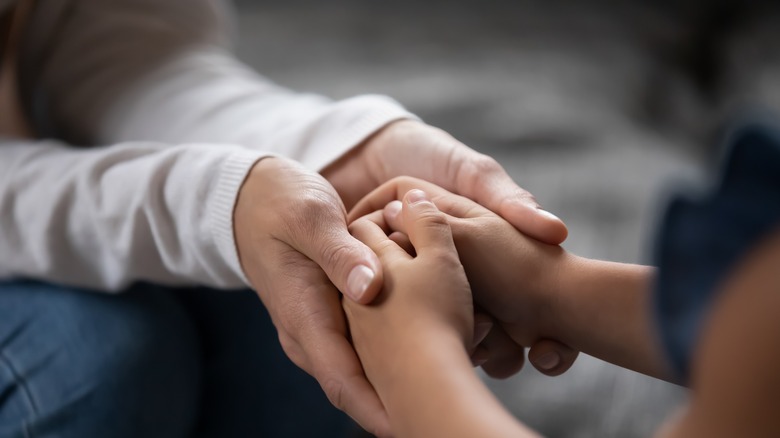 Holding child hands