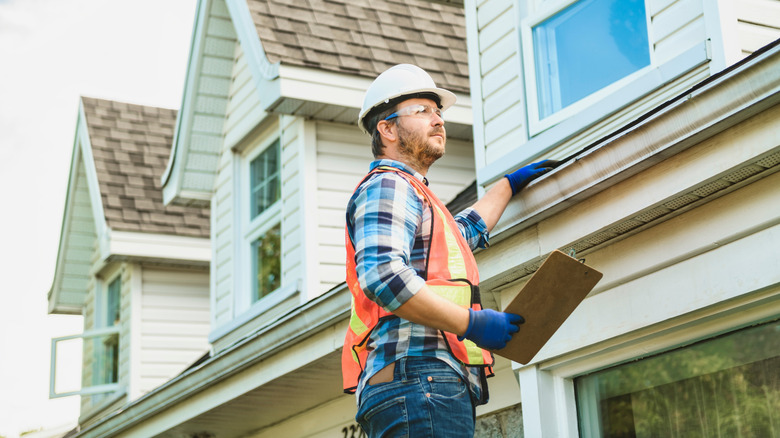 person inspecting roof