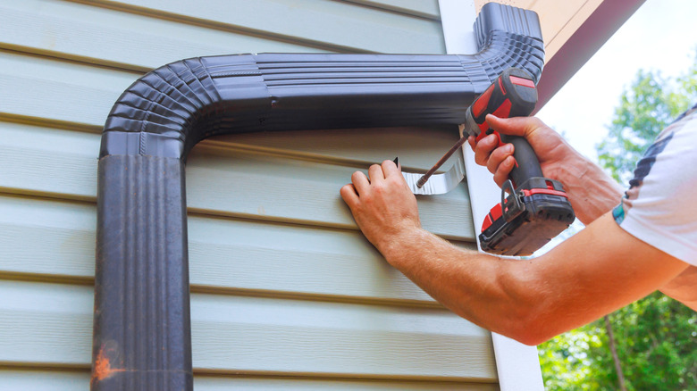 person installing gutter