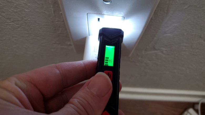 Outlet tester plugged into wall outlet