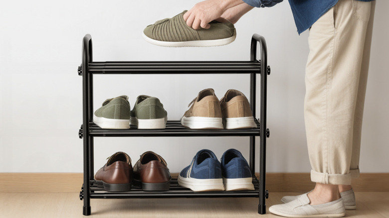 3-tier expandable shoe rack with someone placing shoes on top