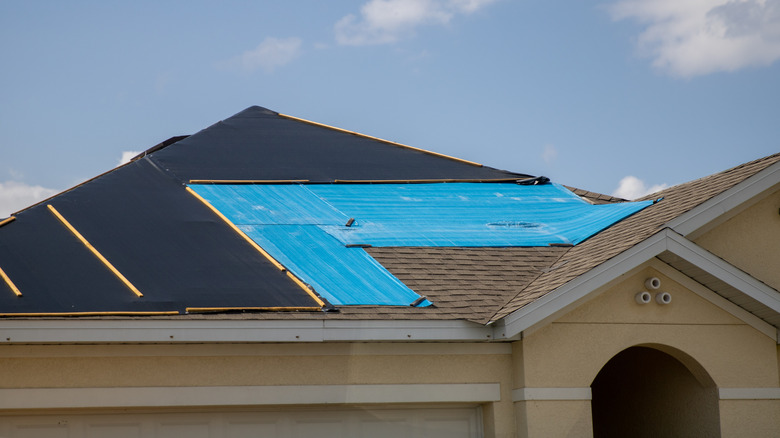 A tarp on a house getting re-roofed.