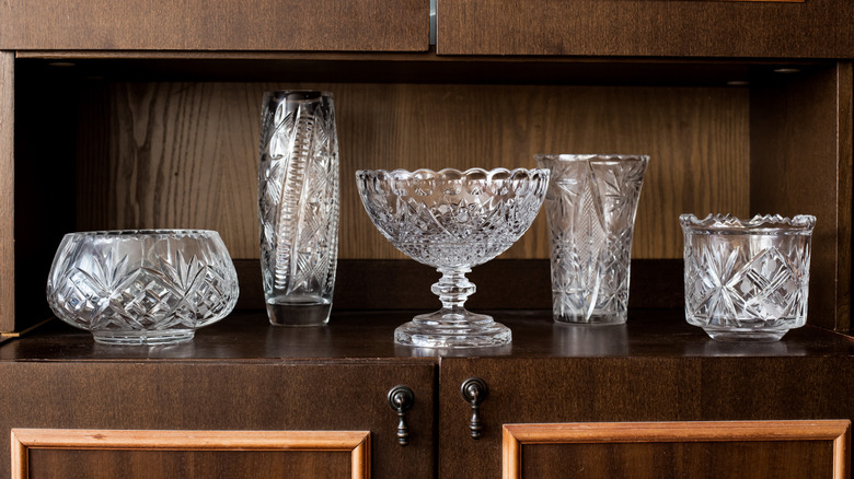 Crystal vases on wooden shelf
