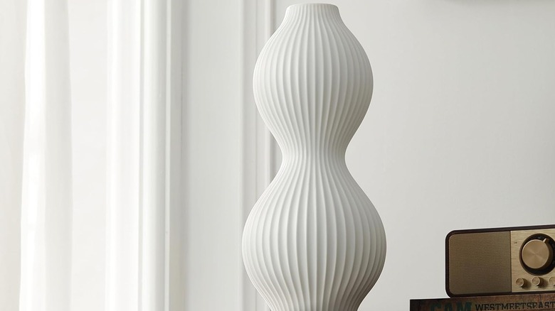 Rondure lamp on table next to radio