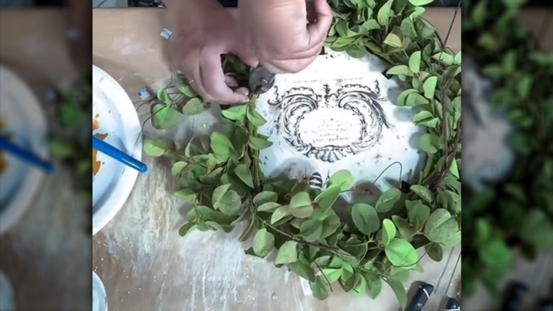 crafter making wreath inlay