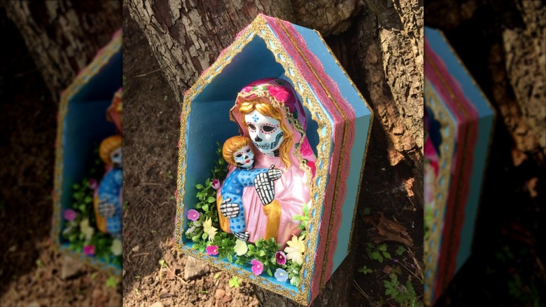Shadowbox with painted figures and flowers