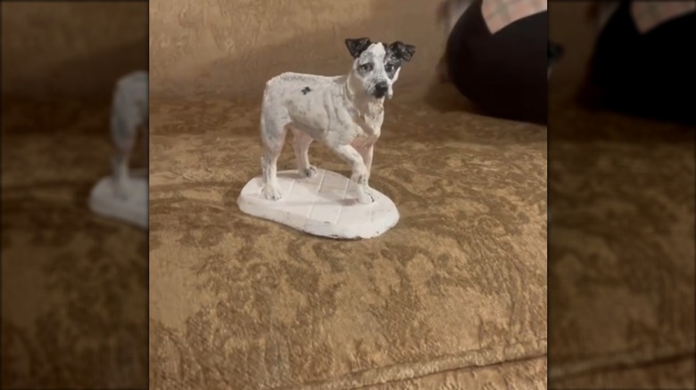 painted dog statue on sofa