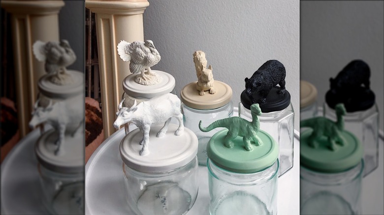 glass jars with painted animal figures attached to lids