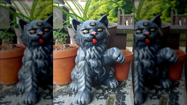 Three-eyed cat upcycled statue