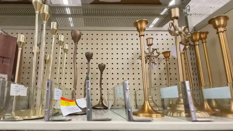 Metallic candleholders on a store shelf