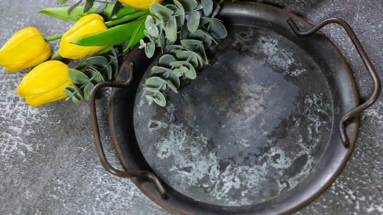 yellow tulip flowers on top of vintage metal tray
